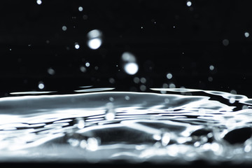 Water droplet splash backgound texture isolated on black. Fresh clean pure water ripples and...