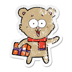 distressed sticker of a laughing teddy  bear with christmas present