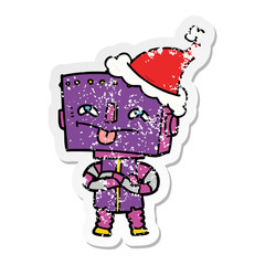 distressed sticker cartoon of a robot wearing santa hat
