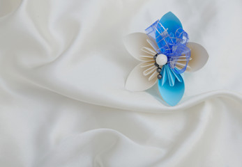 Obraz na płótnie Canvas A beautiful blue and white origami flower on white luxury background