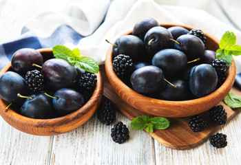 Bowls with fresh plums