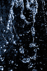 Obraz na płótnie Canvas water jet with splashes on a black background