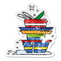 distressed sticker cartoon doodle of a stack of dirty plates