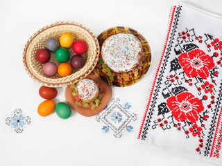 Easter holiday. Easter bread and eggs on a white tablecloth with patterns