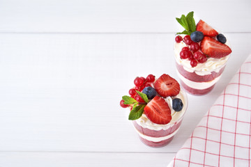 Cake dessert top view. Trifle red velvet in glass with fresh berry, mint leaves.