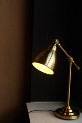 Metal table lamp of gold color. With warm temperature lamp