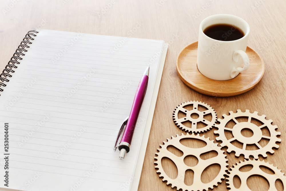 Fototapete top view image of open notebook with blank pages next to cup of coffee on wooden table. ready for ad
