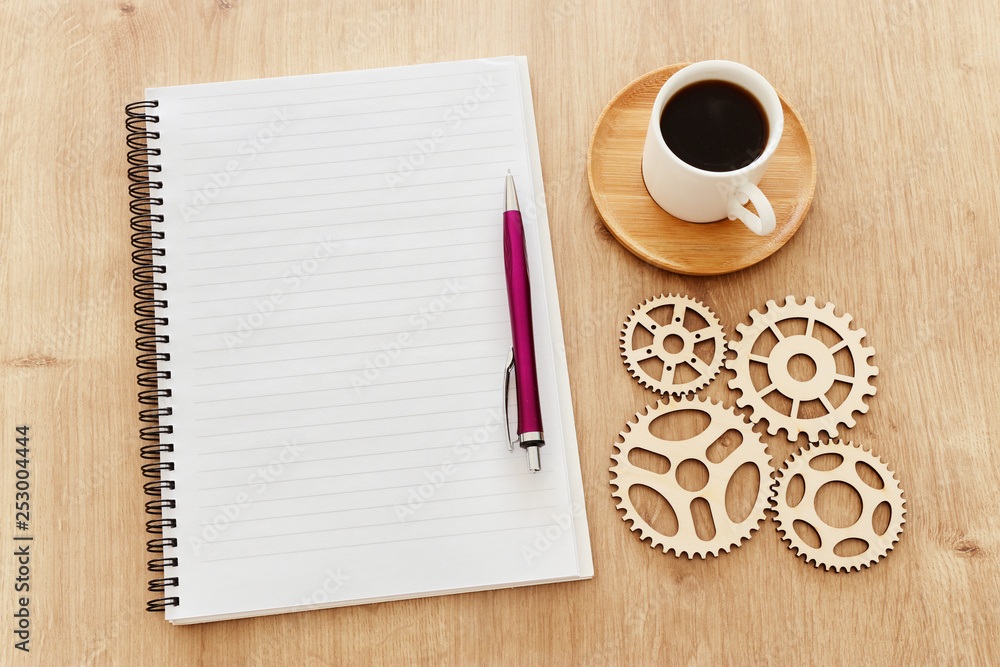 Fototapete top view image of open notebook with blank pages next to cup of coffee on wooden table. ready for ad