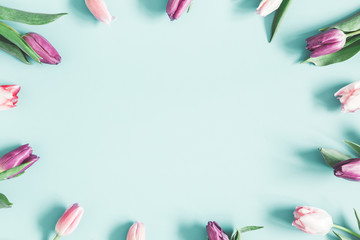 Fototapeta na wymiar Flowers composition. Tulip flowers on pastel blue background. Spring, easter, mothers day, womens day concept. Flat lay, top view, copy space