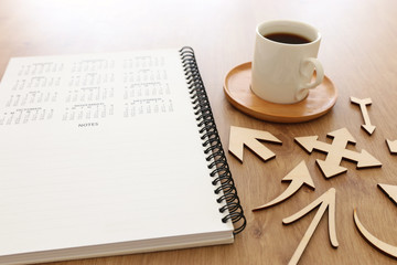 coffee cup and calendar over wooden table