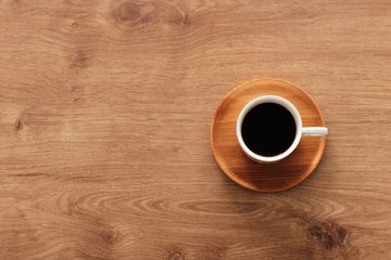 coffee cup over wooden table . top view
