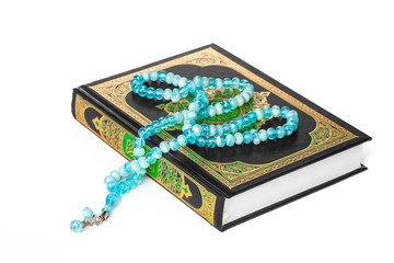 Islamic Book Holy Quran and beads on withe background