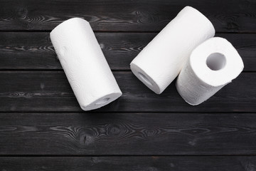 Roll of paper towel on wooden background