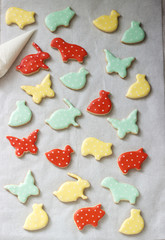 Gingerbread or shortbread cookies of various shapes, covered with colored icing. Spring or summer composition.