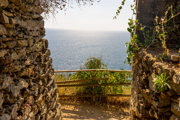 Italy, Cinque Terre, Manarola, a stone bridge over a body of water