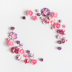 Flowers composition. Wreath made of purple and pink flowers on pastel gray background. Flat lay, top view, copy space, square