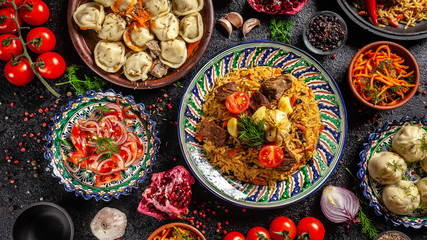 Traditional Uzbek oriental cuisine. Uzbek family table from different dishes in national dishes for...