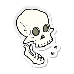 sticker of a cartoon laughing skull