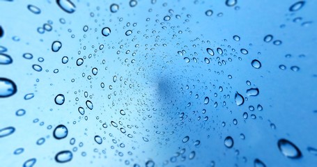 Rain drops on blue glass window background