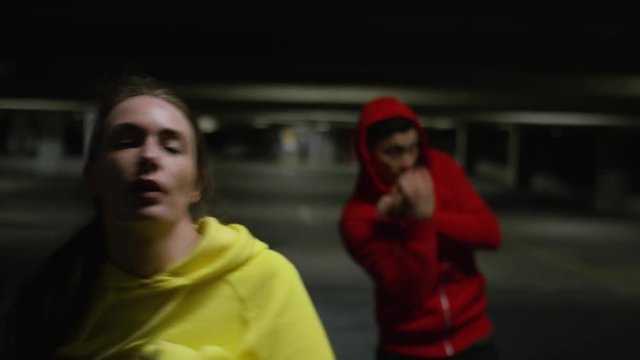 Athletic people in urban boxing fitness class, in slow motion
