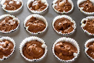 chocolate cupcakes on tray ready for baking