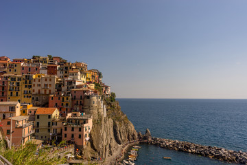 Fototapeta na wymiar Italy, Cinque Terre, Manarola,PANORAMIC VIEW OF SEA AND BUILDINGS AGAINST CLEAR SKY