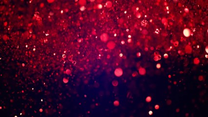 Pink glitter explosion in super slow motion on blue background.