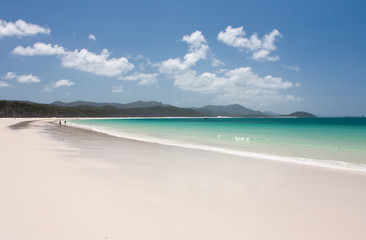 The Whitehaven Beach with people walking in the distance in the Whitsundays in Australia