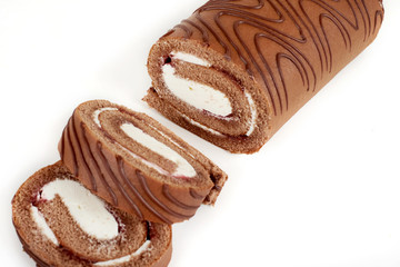 Biscuit roll cut into pieces, on a white background.