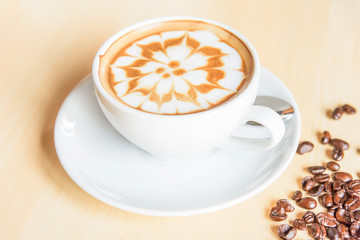 hot cappuccino with nice milk pattern and coffee bean