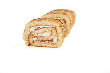 Biscuit roll cut into pieces, on a white background.