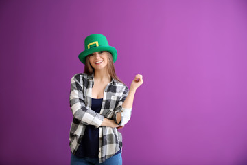 Beautiful young woman in green hat on color background. St. Patrick's Day celebration