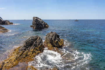 Fototapeta na wymiar Italy, Cinque Terre, Manarola, a rocky shore next to a body of water