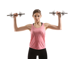 Fototapeta na wymiar Sporty young woman with dumbbells on white background