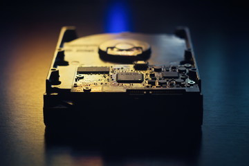 Hard disk on the table in dark colors and lighting close-up.