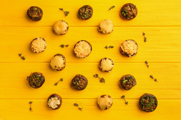 Tasty stuffed mushrooms on color wooden background