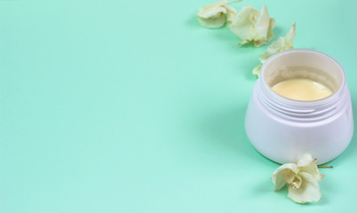Natural cosmetic products on a blue background..A jar of natural cosmetic cream