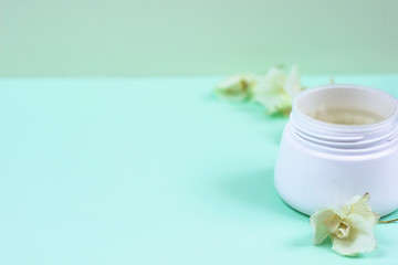 Natural cosmetic products on a blue background..A jar of natural cosmetic cream