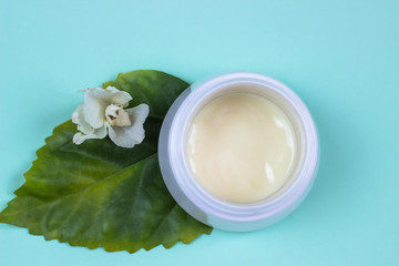 Natural cosmetic products on a blue background..A jar of natural cosmetic cream