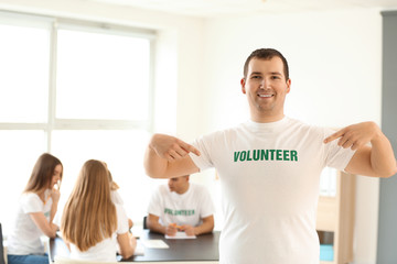 Young male volunteer at meeting indoors