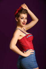 Beautiful pin-up woman on color background
