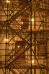 Fototapeta premium Scaffolding and industrial lights in diagonal pattern in Chelsea, Manhattan, New York City at night