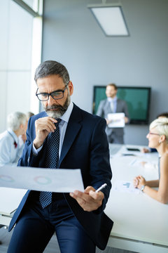 Successful Team Leader And Business Owner Leading Informal In-house Business Meeting