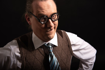 Funny nerd or geek looking through camera and thinking