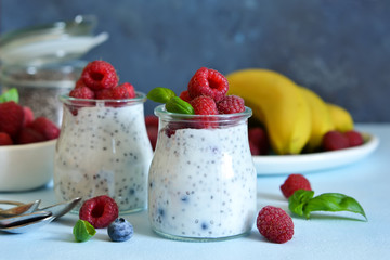 Vanilla yoghurt with raspberries and banana for breakfast. Dietary meals.