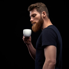Bearded man tasting coffee