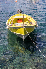 Italy, Cinque Terre, Manarola, a small yellow boat on a body of water