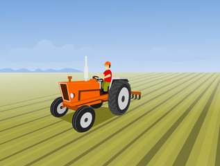 tractor in field.The man is driving a orange tractor. In order to plow the soil in the field. Have a blue sky background