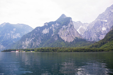 Large stone mountains in the Alps on Konigssee Lake