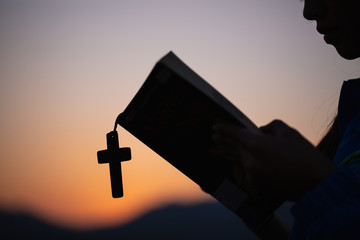 Women hand  pray to God with the Bible and the cross of the morning. Woman Pray for god blessing to...